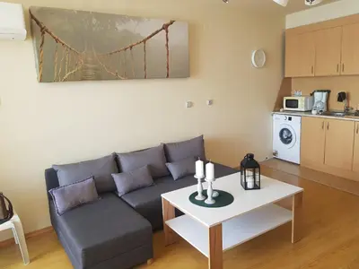 a living room with a couch and a table at Sozopol Bulgaria VIP zona in Sozopol