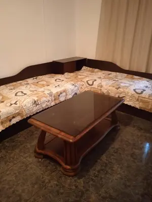 a coffee table in front of a bed at Апартамент Браво in Sunny Beach