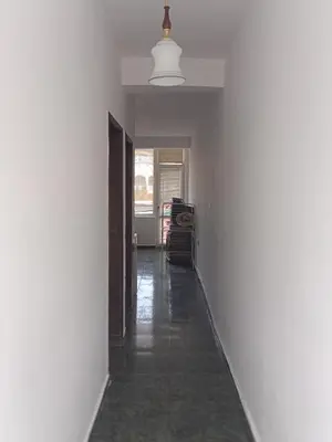 a hallway with a white wall and a white ceiling at Апартамент Браво in Sunny Beach