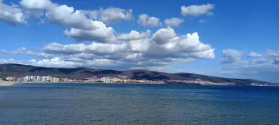 a large body of water with a city and mountains at Апартамент Браво in Sunny Beach