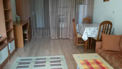 a living room with a couch and a dining room table at Cozy 1 bed apartment in Lesso Complex (Ravda, Nessebar) in Ravda