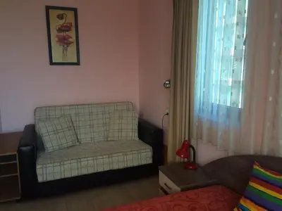 a living room with a chair and a window at Cozy 1 bed apartment in Lesso Complex (Ravda, Nessebar) in Ravda