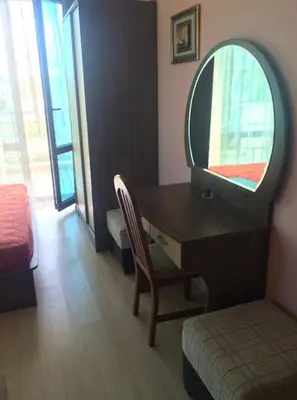 a bedroom with a desk with a mirror and a bed at Cozy 1 bed apartment in Lesso Complex (Ravda, Nessebar) in Ravda