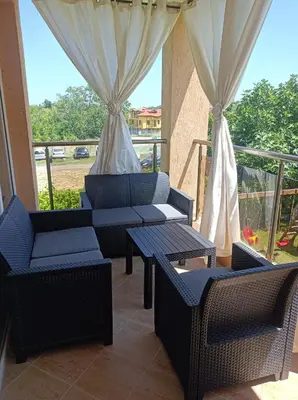 a patio with chairs and tables and a balcony at Sozopoli Hills, app B7 in Sozopol
