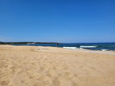 a person standing on a sandy beach near the ocean at Sozopoli Hills, app B7 in Sozopol