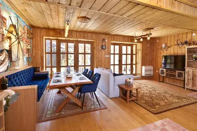 a living room with a table and a couch at ВИЛА ТЪРТЕФФ in Nesebar