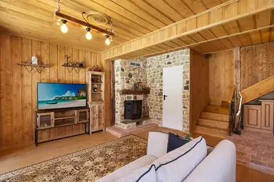 a living room with a couch and a television at ВИЛА ТЪРТЕФФ in Nesebar