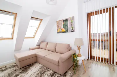 a living room with a couch and windows at BohoTide by the Sea in Bliznatsi