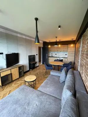 a living room with a couch and a table at Sea Scenery Apartment in Burgas City
