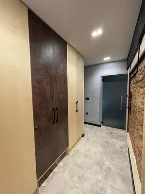 a locker room with wooden doors and a brick wall at Sea Scenery Apartment in Burgas City