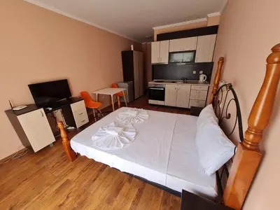 a bedroom with a large bed and a kitchen at MitProt Panorama Bay 2 ap 31 in Sveti Vlas