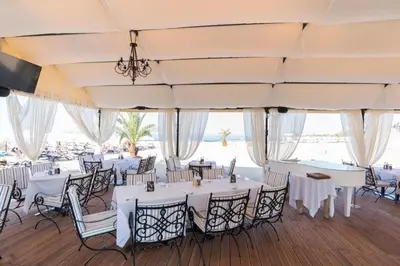 a banquet hall with white tables and chairs at Oasis Resort & Spa Cozy Studio in Lozenets