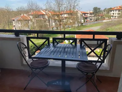 a blue table and two chairs on a balcony at Oasis Resort & Spa Cozy Studio in Lozenets
