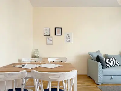 a dining room table with chairs and a couch at Lovely Apartment with Balcony in Pomorie Old Town by Flat Mаnаger in Pomorie