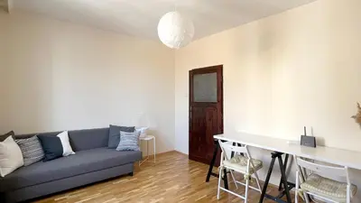 a living room with a couch and a table at Lovely Apartment with Balcony in Pomorie Old Town by Flat Mаnаger in Pomorie