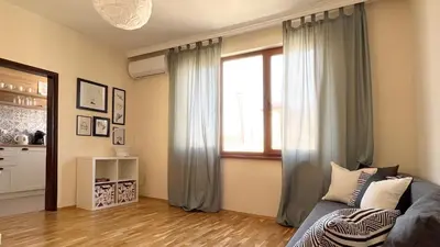 a living room with a couch and a window at Lovely Apartment with Balcony in Pomorie Old Town by Flat Mаnаger in Pomorie