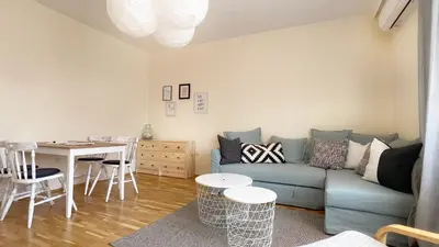 a living room with a blue couch and a table at Lovely Apartment with Balcony in Pomorie Old Town by Flat Mаnаger in Pomorie
