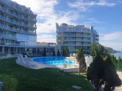 a large building with a swimming pool next to a building at Studio Silver Terace with Sea View for 4 person in Byala