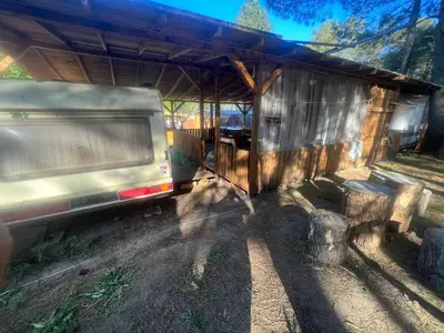 a truck parked in front of a shed at Каравана Чайка in Sozopol