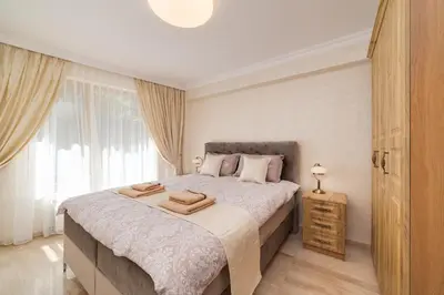 a bedroom with a bed with two towels on it at Deluxe and Central Garden Apartment in Varna City