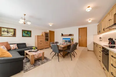 a living room with a couch and a table at Deluxe and Central Garden Apartment in Varna City