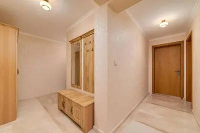 a dressing room with a bench and a door at Deluxe and Central Garden Apartment in Varna City