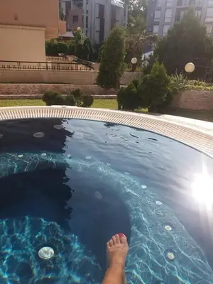 a person is laying in a swimming pool at Апартамент в Рейнбоу 3 in Sunny Beach