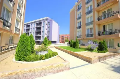 an apartment complex with a courtyard with trees and buildings at Апартамент в Рейнбоу 3 in Sunny Beach