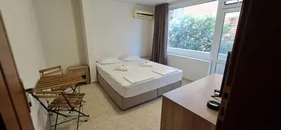 a small room with a bed and a window at Къща за гости Беглик Таш 2 in Primorsko