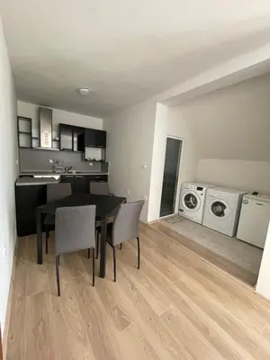 a kitchen and dining room with a table and chairs at Къща за гости Беглик Таш 2 in Primorsko