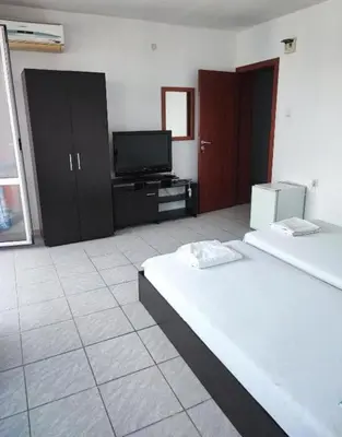 a bedroom with two beds and a flat screen tv at Fa Mol in Sunny Beach