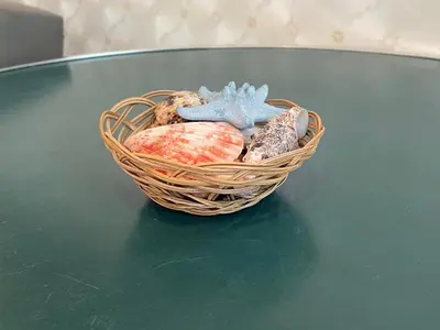 a basket of seashells and a starfish on a table at Sunny Studio in Sunny Beach by Flat Mаnаger in Sunny Beach