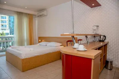a bedroom with a bed and a kitchen with a counter at Sunny Studio in Sunny Beach by Flat Mаnаger in Sunny Beach