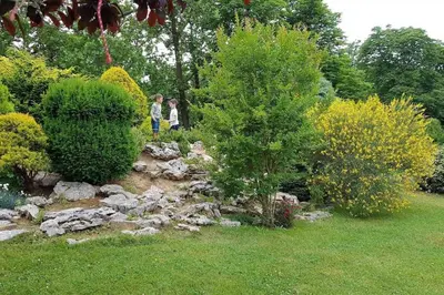 two children are walking through a rock garden at Апартамент Ели in Obzor