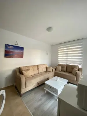 a living room with a couch and a coffee table at Апартамент Ели in Obzor