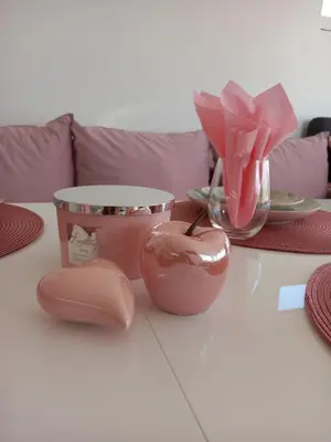 a table with a pink flower in a vase at Perla 2 studio in Burgas City