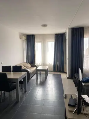 a living room with a couch and a table at Luxory Apartament on the Seaside, Gradina beach, St Nicholas Complex in Chernomorets