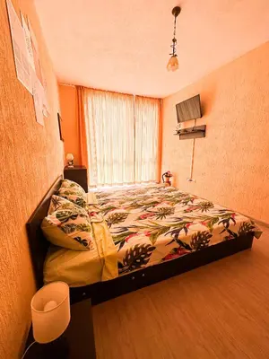 a bedroom with a bed and a window at Blue Sky Apartments in Nesebar