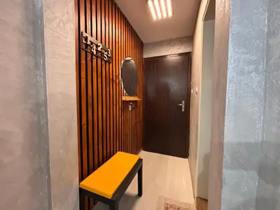 a yellow bench in a hallway with a door at Sozopol Romance Apartments in Sozopol