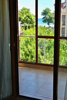 an open window with a view of the ocean at Апартамент Limoncini in Sozopol
