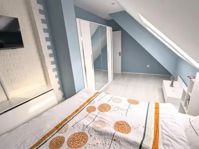 a bedroom with a bed in a room with blue walls at ~ The Blue ~ 1BD Flat near Asparuhovo Sea Garden in Varna City