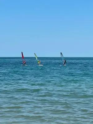 three people windsurfing in the ocean on the water at Studio in Sveti Vlas