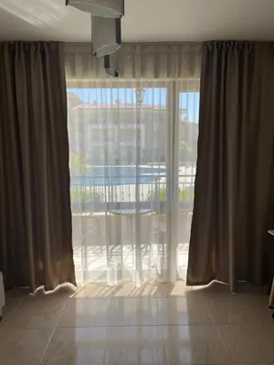 a room with a large window with a view of a patio at Studio in Sveti Vlas