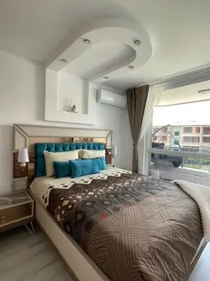 a bedroom with a large bed with a large window at Brand new first line Sea view 1 bedroom apartment in Burgas City