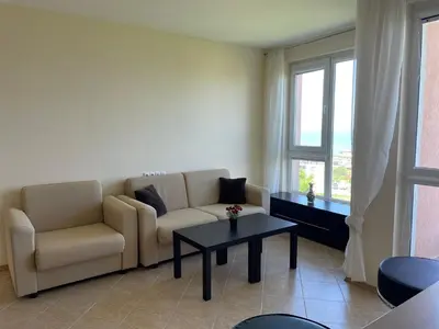 a living room with a couch and a table at Nieli-1 SP apartments in Byala
