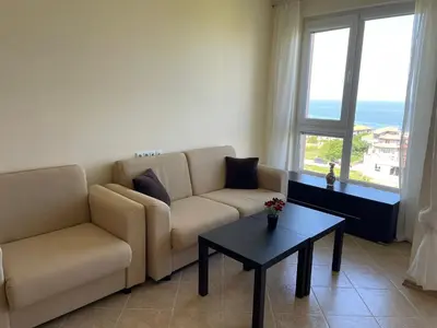 a living room with a couch and a table at Nieli-1 SP apartments in Byala