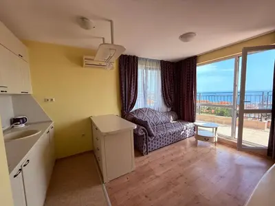 a living room with a couch and a view of the ocean at Nieli-1 SP apartments in Byala