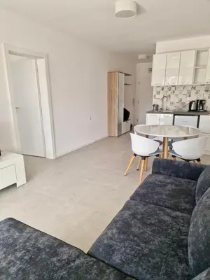 a living room with a couch and a table at Green Life Private apartments in Sozopol