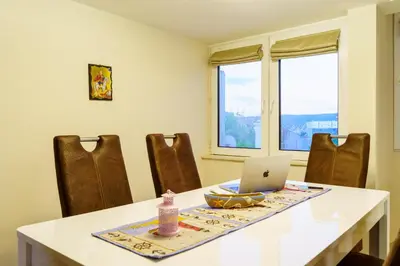 a dining room table with a laptop computer on it at Centrally Located Apartment in Varna in Varna City