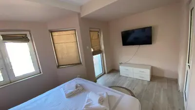 a bedroom with a bed and a tv on the wall at Centrally Located Apartment in Varna in Varna City